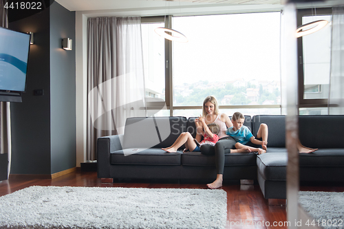 Image of young mother spending time with kids