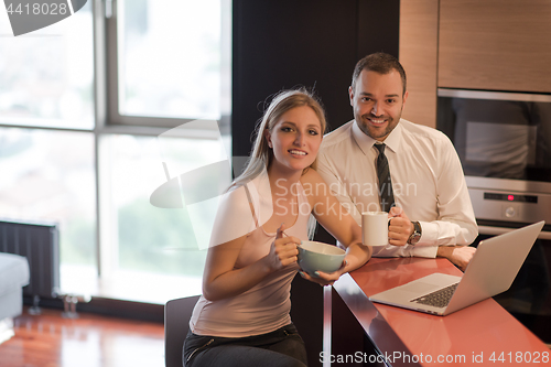 Image of A young couple is preparing for a job and using a laptop