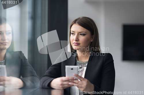 Image of Business Girl Standing In A Modern Building Near The Window With