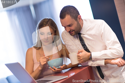 Image of A young couple is preparing for a job and using a laptop