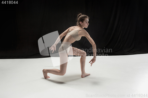 Image of Young teen dancer on white floor background.