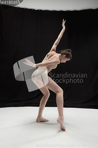 Image of Young teen dancer on white floor background.