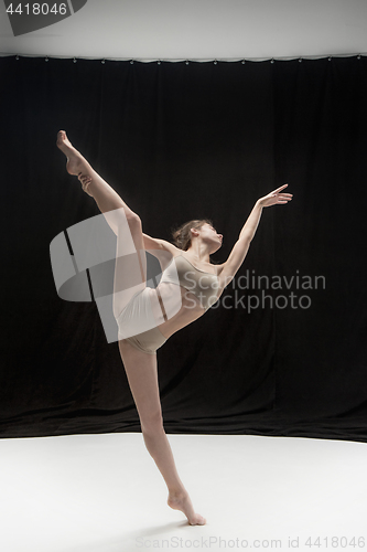 Image of Young teen dancer on white floor background.