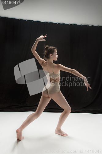 Image of Young teen dancer on white floor background.