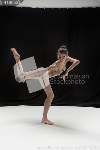 Image of Young teen dancer on white floor background.