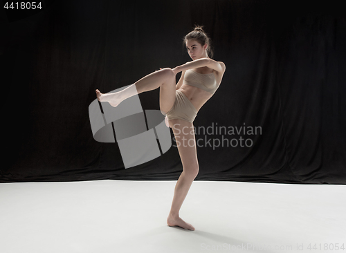 Image of Young teen dancer on white floor background.