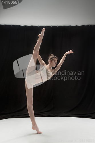 Image of Young teen dancer on white floor background.