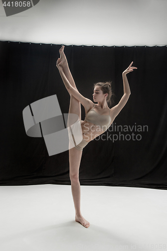 Image of Young teen dancer on white floor background.