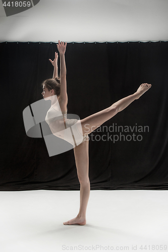 Image of Young teen dancer on white floor background.