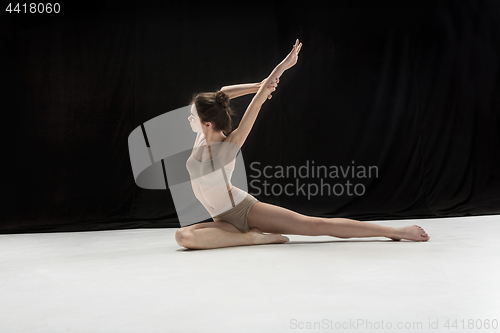 Image of Young teen dancer on white floor background.