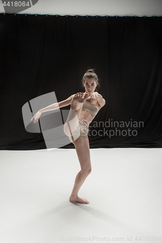 Image of Young teen dancer on white floor background.