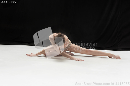 Image of Young teen dancer on white floor background.