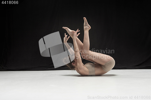 Image of Young teen dancer on white floor background.