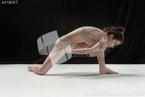 Image of Young teen dancer on white floor background.