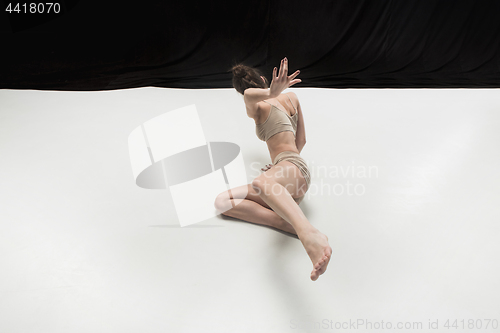 Image of Young teen dancer on white floor background.