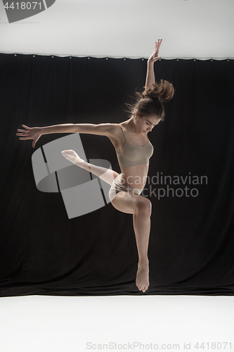 Image of Young teen dancer on white floor background.