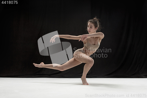 Image of Young teen dancer on white floor background.