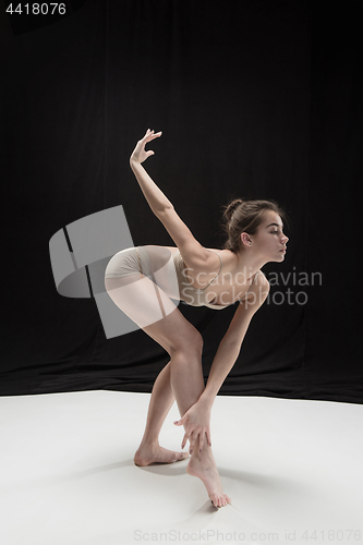 Image of Young teen dancer on white floor background.