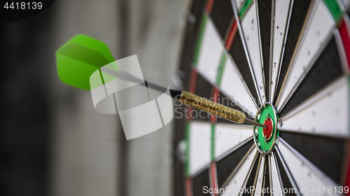 Image of a typical darts game with dart in the bullseye