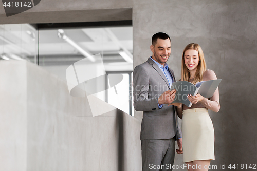 Image of businesswoman and businessman with folder