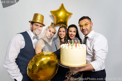 Image of happy friends with big cake at birthday party