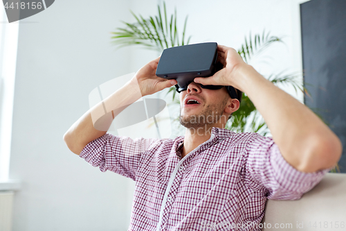 Image of happy man with virtual reality headset at office