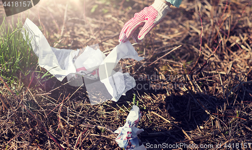 Image of volunteer hand cleaning area from garbage