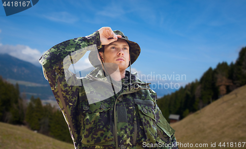 Image of young soldier in military uniform outdoors