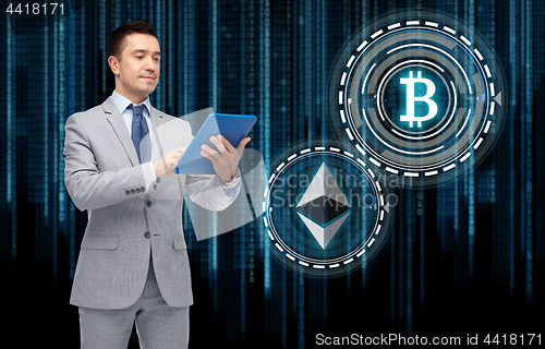 Image of businessman with tablet pc and cryptocurrency