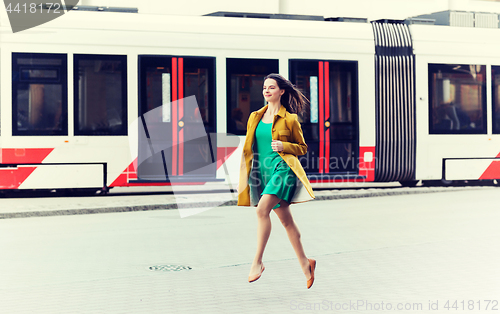 Image of happy young woman or teenage girl on city street