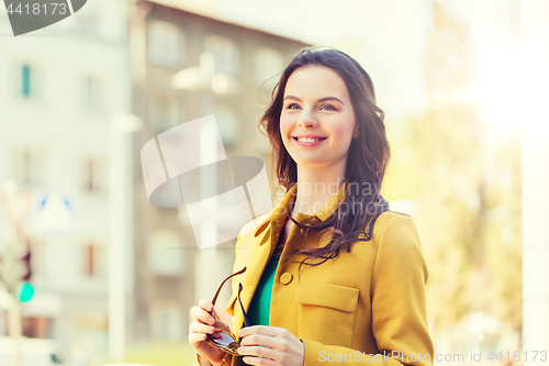 Image of smiling young woman in city