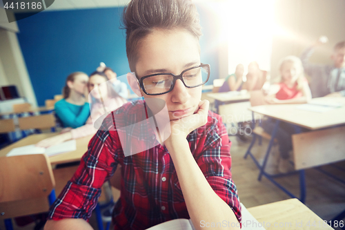 Image of students gossiping behind classmate back at school