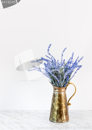 Image of Blue lavender in antique metal jar