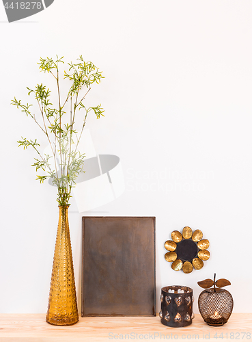 Image of Home decor composition with tree branches and metal objects 