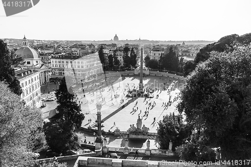 Image of Aerial view of people, sculptures, fountain and churches on Piazza del Popolo in Rome, Italy.
