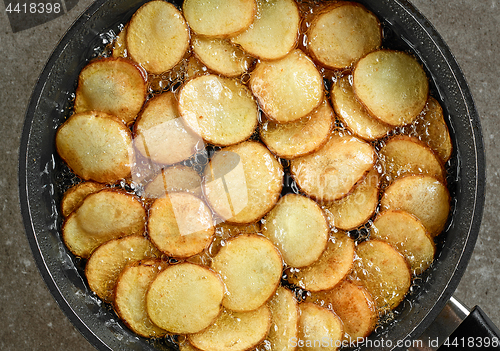 Image of frying potatoes in pan with oil