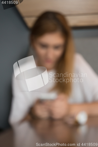 Image of young woman using mobile phone