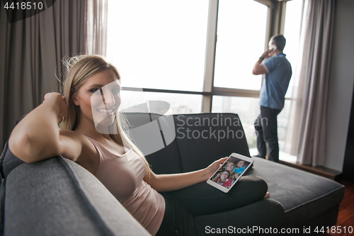 Image of woman using tablet in beautiful apartment