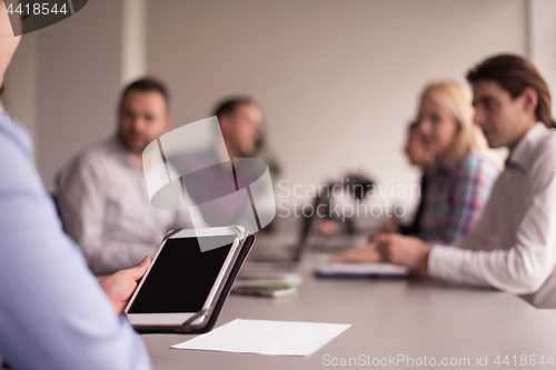 Image of Businessman using tablet in modern office