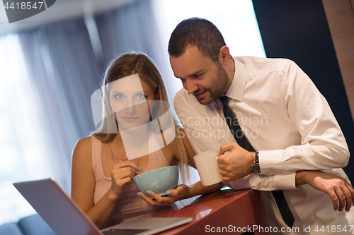 Image of A young couple is preparing for a job and using a laptop