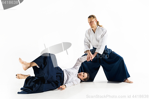 Image of Man and woman fighting at Aikido training in martial arts school