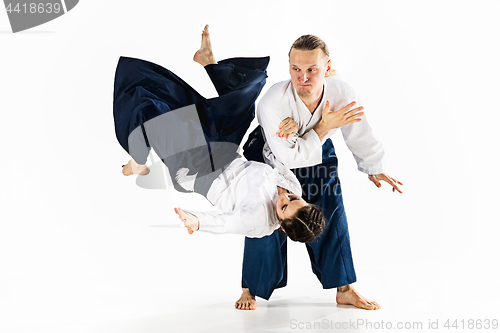 Image of Man and woman fighting at Aikido training in martial arts school