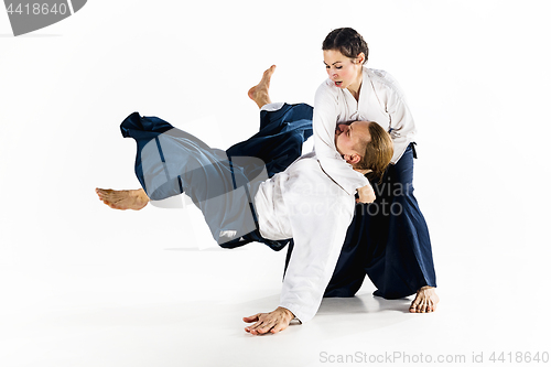 Image of Man and woman fighting at Aikido training in martial arts school