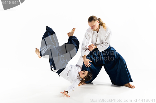 Image of Man and woman fighting at Aikido training in martial arts school