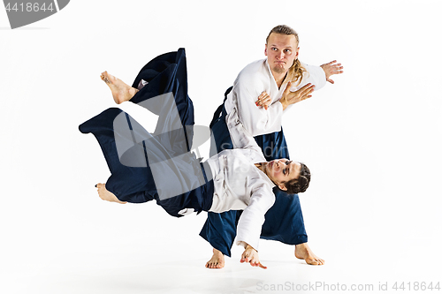 Image of Man and woman fighting at Aikido training in martial arts school