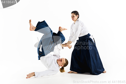 Image of Man and woman fighting at Aikido training in martial arts school