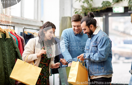 Image of friends shopping bags at vintage clothing store