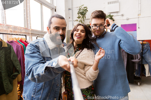 Image of friends taking selfie at vintage clothing store