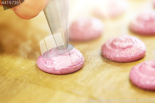 Image of chef with nozzle squeezing macaron batter