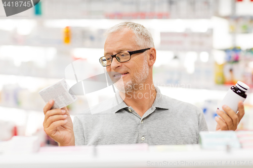 Image of senior male customer choosing drugs at pharmacy